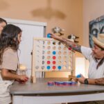 Rodzina gra w Connect Four w domu, wspólna zabawa bez barier